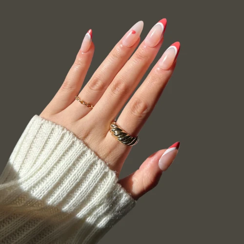 image of girls hand having Classic French Manicure with Red Tips