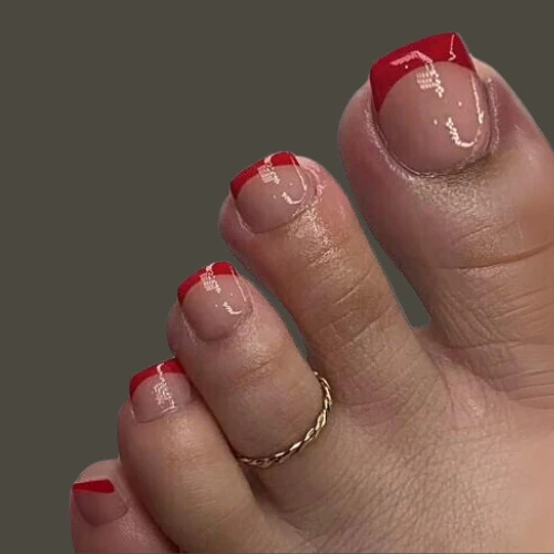 girls feet haveing Red French Tip Nails Toes